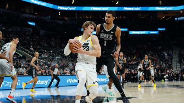 Dec 26, 2023; San Antonio, Texas, USA; Utah Jazz forward Lauri Markkanen (23) keeps the ball from San Antonio Spurs center Victor Wembanyama (1) in the second half at Frost Bank Center.